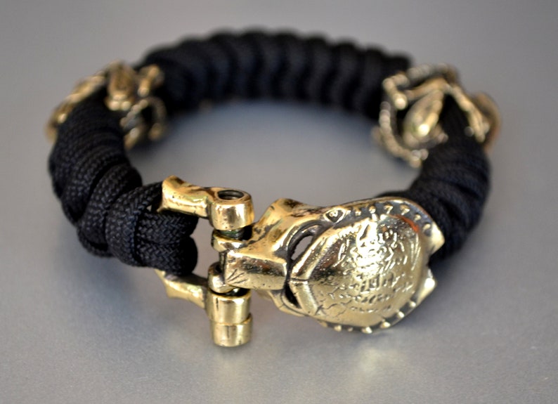 Paracord bracelet with Predator brass shackle alien beads Etsy
