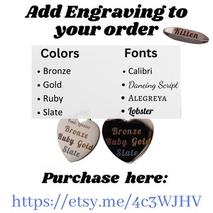 a couple of heart shaped brooches sitting on top of each other