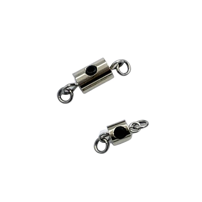 May include: Two silver metal clasps with black accents and small loops on each end. The clasps are designed to connect two pieces of jewelry together.