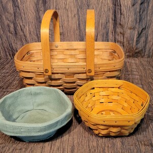 May include: Three woven baskets, one large rectangular basket with two handles, one smaller round basket, and one smaller hexagonal basket.