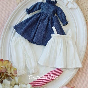 May include: A white ceramic mug with a black handle and the text "But First, Coffee" in a handwritten style. The mug is on a white surface. The mug is approximately 4 inches tall.