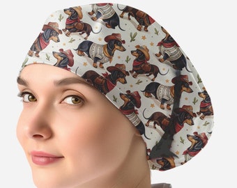 May include: A scrub cap featuring a repeating pattern of dachshunds wearing cowboy hats, red bandanas, and sweaters on a cream background. The design includes small green cactus and yellow star icons scattered among the dogs.