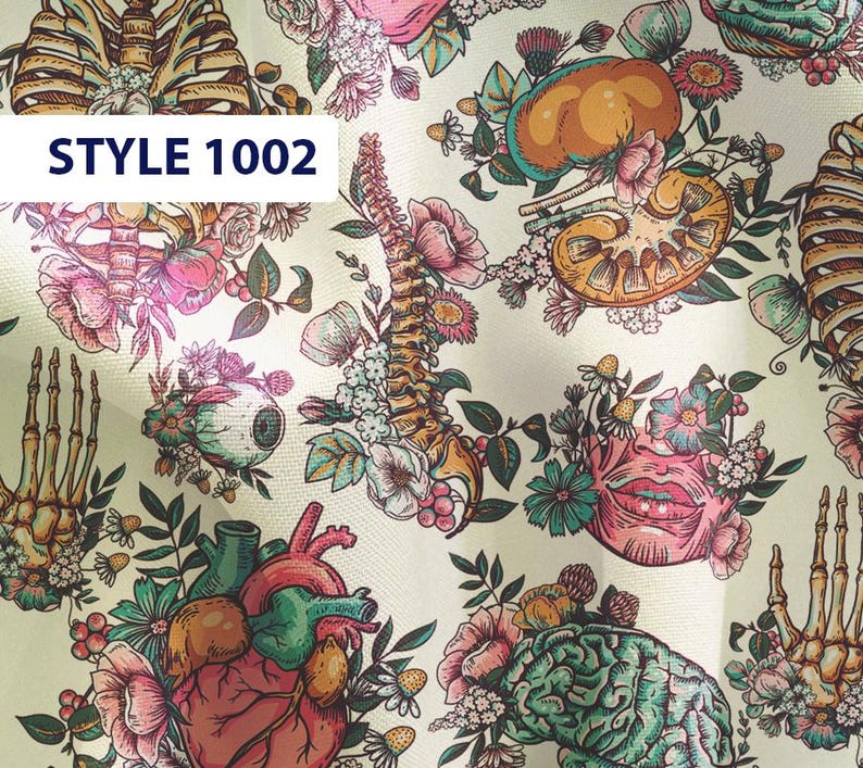 May include: A white fabric with a colorful anatomical pattern. The pattern includes a heart, brain, lungs, spine, and skeleton. The fabric is decorated with flowers and leaves. The text "STYLE 1002" is printed on the fabric.