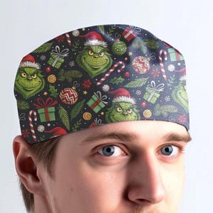 May include: A scrub cap featuring a dark background with a repeating pattern of green Grinch faces wearing red Santa hats, interspersed with red and white candy canes, green gift boxes with red ribbons, and colorful Christmas ornaments.