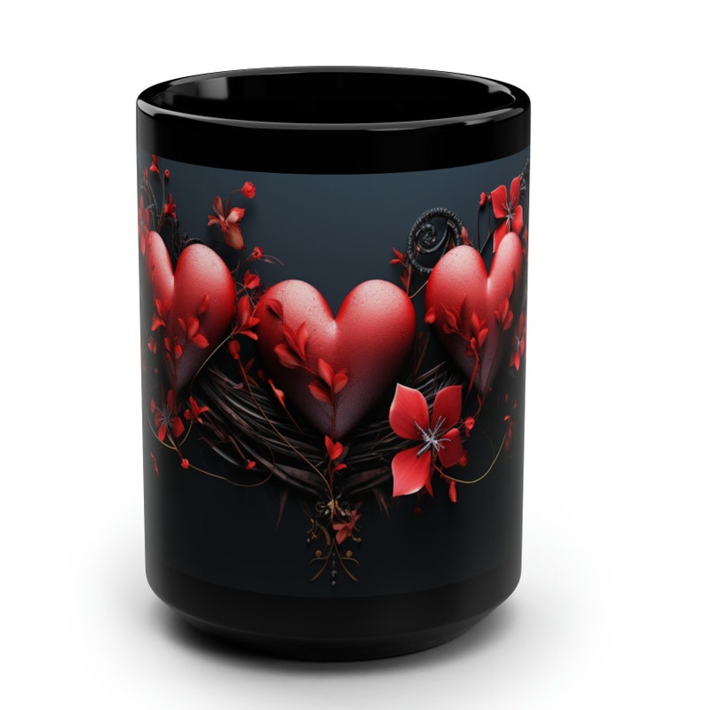 May include: Black coffee mug with a design of three red hearts surrounded by red flowers and vines on a dark blue background.