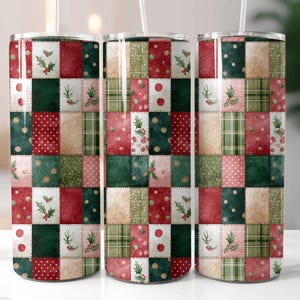 May include: Three insulated stainless steel tumblers with a patchwork design. The design features squares of red, green, and beige with holly and polka dot accents. Each tumbler has a clear lid and a straw.