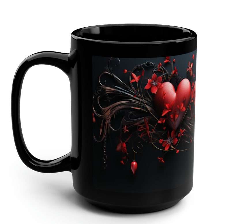 May include: Black coffee mug with a red heart surrounded by black and red floral designs.