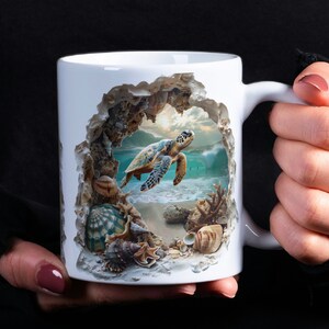 K&ouml;nnte beinhalten: Eine wei&szlig;e Keramiktasse mit einem 3D-Design einer Meeresschildkr&ouml;te, die durch eine zerbrochene Felsformation schwimmt. Die Schildkr&ouml;te ist gr&uuml;n, braun und gelb mit einem blauen Ozean dahinter. Die Tasse ist von Muscheln und Korallen umgeben.