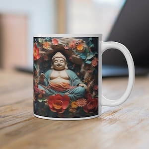 May include: White ceramic mug featuring a serene Buddha statue surrounded by colorful flowers and foliage. The Buddha is depicted in a seated position, wearing a blue robe. The mug has a standard handle and is suitable for hot or cold beverages.