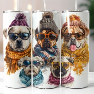 May include: Three stainless steel tumblers with a white background and colorful illustrations of dogs wearing winter hats and scarves. The dogs are wearing sunglasses and have different colored scarves.