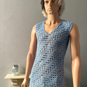 May include: A light blue, sleeveless, crochet top with a V-neck. The open weave design creates a diamond pattern across the front. The top is displayed on a mannequin.