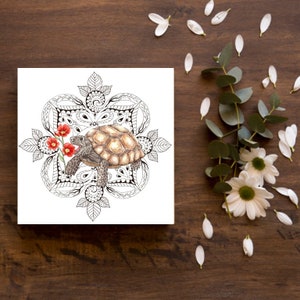 May include: A black and white mandala design with a brown tortoise in the center. The tortoise is surrounded by red flowers.