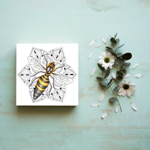 May include: A black and white mandala with a yellow and black bee in the center. The bee has wings and a stinger. The mandala is intricate and detailed.
