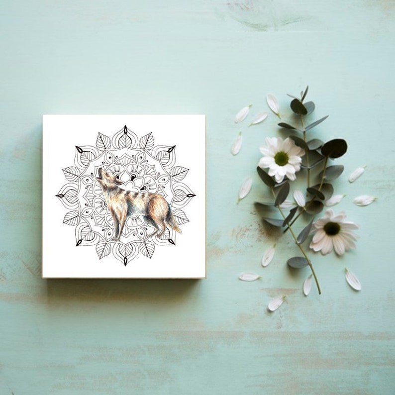 May include: A black and white mandala with a brown and white wolf howling inside. The wolf is surrounded by a circular pattern of leaves and flowers.