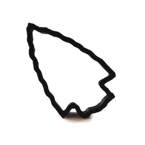 May include: A black, stylized cursor outline, resembling a computer mouse pointer. The outline is thick and has a slightly textured appearance, set against a clean white background. The design is simple and modern.