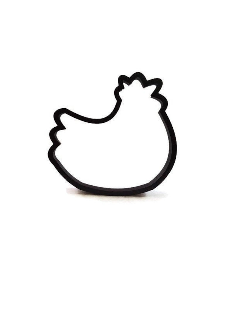 May include: Black outline of a hen cookie cutter. The cookie cutter is in the shape of a hen, with a detailed comb and wattle. The hen is facing left, with a rounded body and a curved tail. The cookie cutter is made of a dark material.