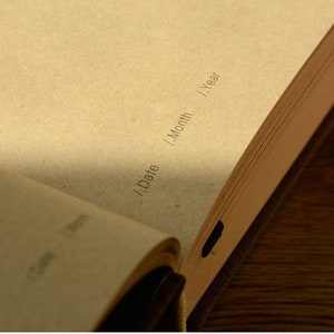 May include: A brown leather-bound journal with 365 pages. The pages are numbered and have lines for writing. The journal has a simple design and is perfect for daily journaling.