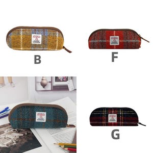 May include: A collection of eight pencil cases labeled A through H, each featuring a unique plaid or herringbone wool pattern, a brown zipper closure, and a white rectangular Harris Tweed brand label centered on the front of the pouch.