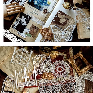 May include: A set of white paper die cuts featuring intricate designs of gates, fences, and circular patterns. The die cuts are arranged on a wooden surface with a book and other decorative elements.