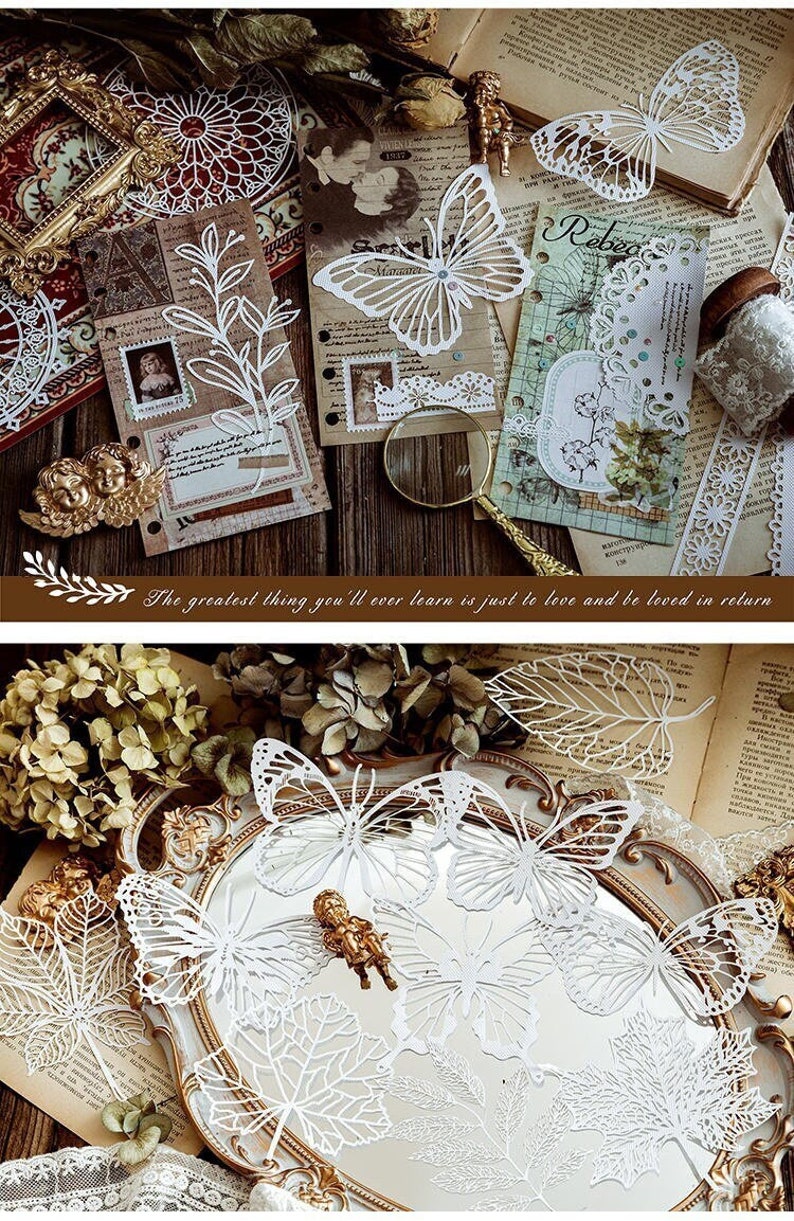 May include: White paper cutouts of butterflies and leaves. The butterflies have intricate designs and are arranged on a silver tray with a gold rim. The leaves are also intricately cut and have a delicate lace-like appearance.
