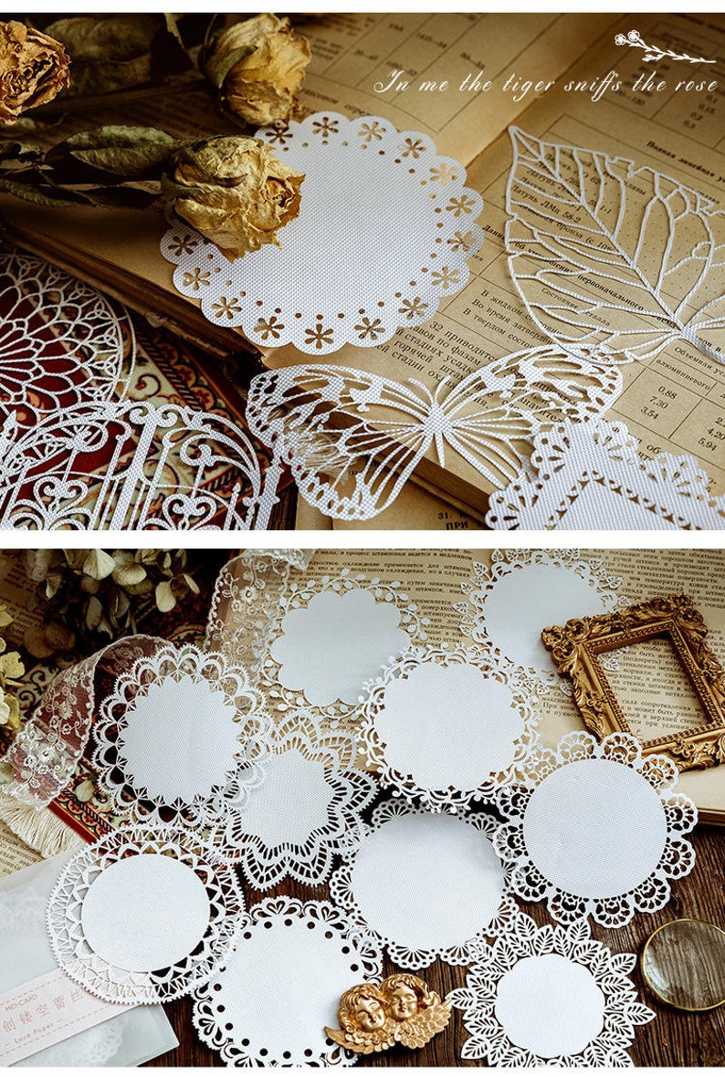 May include: A set of white paper doilies with intricate lace designs. The doilies are arranged on a book with a brown cover and a white background. The book has text in a foreign language. The doilies are perfect for adding a touch of elegance to any occasion.