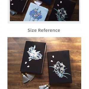 May include: A5 size notebook cover with embroidered floral designs in shades of blue, white, and pink. The cover is made of black fabric with white tassels. The text "Size Reference" is visible below the image.