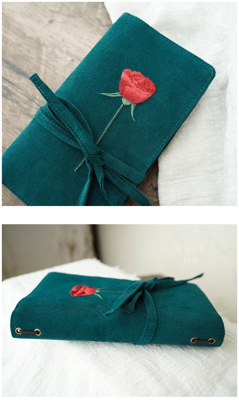 May include: A green corduroy notebook with a red embroidered rose and a green ribbon tied around it. The notebook has two brass rings on the side.