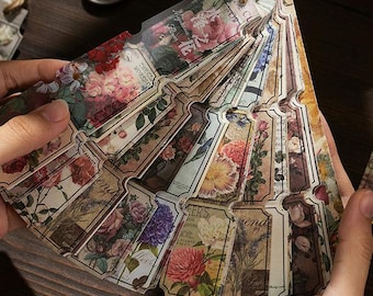 May include: A set of vintage-style floral patterned paper tags with a decorative, rustic, and floral theme. The tags are arranged in a fan shape and feature various floral designs and text.