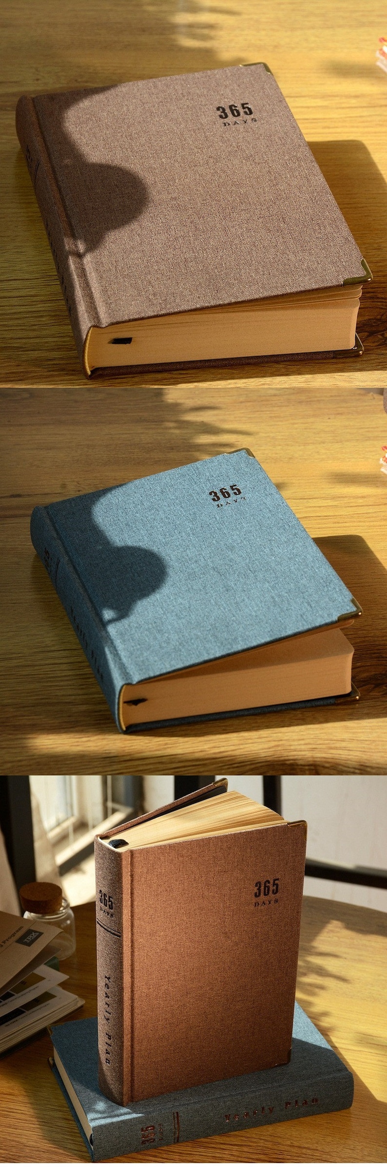 May include: Three brown, blue, and brown hardcover journals with gold accents. Each journal has the text "365 Days" printed on the front cover.