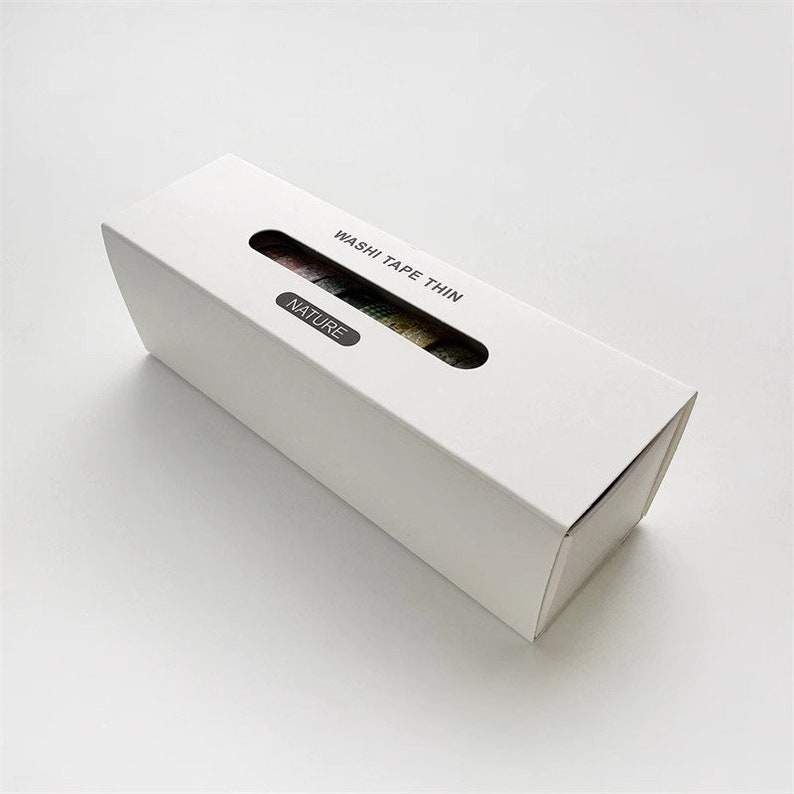 May include: A white box with a window showing colorful washi tape rolls. The box is labeled "Washi Tape Thin" and "Nature".