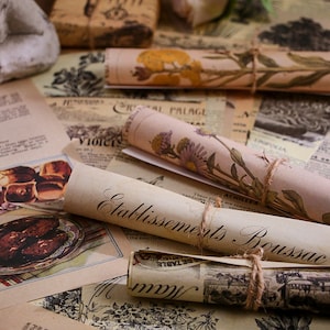 May include: Vintage style paper scraps with floral and botanical illustrations. The paper is rolled up and tied with twine. The text on the paper reads "Etablissements Boussac".
