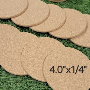 May include: A set of 10 round cork coasters, each measuring 4 inches in diameter and 1/4 inch thick. The coasters are arranged in a semi-circle on a green artificial grass surface.