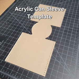 May include: A tan acrylic can sleeve template with the words "Acrylic Can Sleeve Template" in white. The template has a square top and bottom with a circular cutout in the middle. The edges have small holes for stitching.