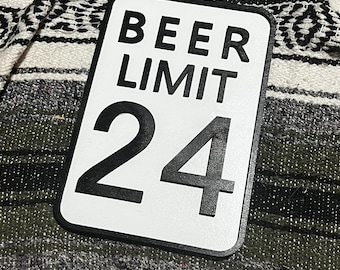 May include: White sign with black text that reads "BEER LIMIT 24".