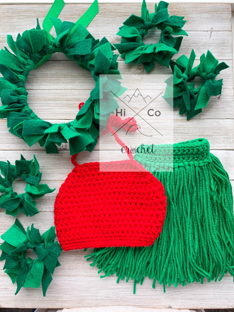 May include: A red crocheted hat with green fringe, a green felt wreath, and four smaller green felt wreaths. The text "Hi Co Crochet" is visible in the background.