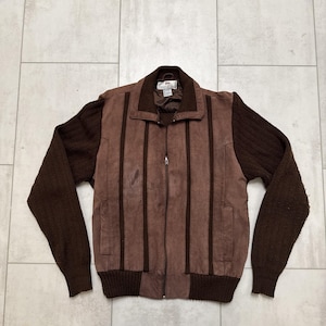 May include: A brown vintage jacket with a zip-up front. The jacket features vertical leather panels down the front and knit sleeves. The collar and cuffs are also knit. The jacket is a medium size.