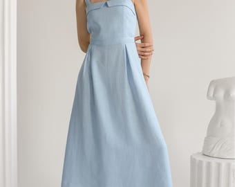 May include: A light blue sleeveless midi dress with a square neckline and a small collar. The dress has a fitted bodice and a flowy skirt.