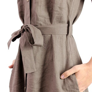 May include: A brown linen dress with a self-tie belt and a button-up front.