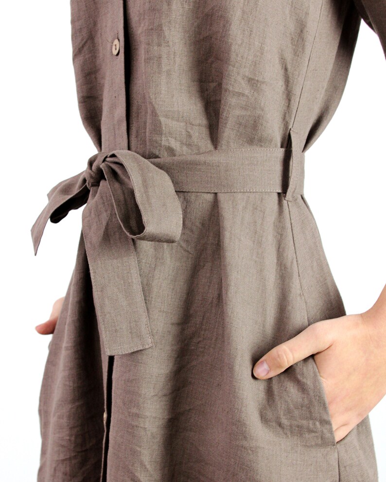 May include: A brown linen dress with a self-tie belt and a button-up front.