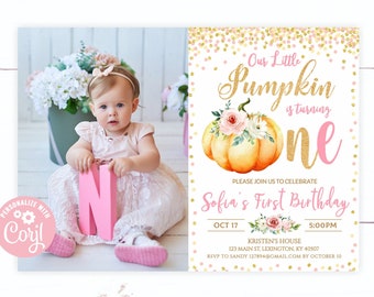 May include: A pink and gold first birthday invitation featuring a watercolor pumpkin and floral accents. The invitation includes a photo of a baby girl holding a pink letter "N". The text reads "Our Little Pumpkin is turning one."