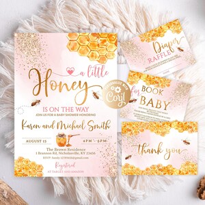 May include: A pink and gold baby shower invitation with a honeycomb pattern and the text "a little Honey is on the way". The invitation includes the names "Karen and Michael Smith" and the date "August 15".