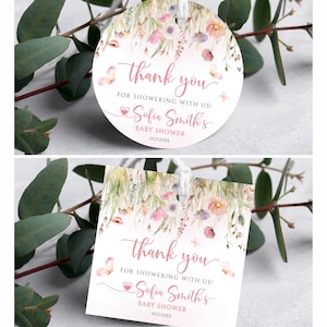 May include: Two baby shower thank you tags, one round and one square, with floral and butterfly designs. The tags read "thank you for showering with us! Sofia Smith's Baby Shower 10.21.20XX". The tags are white with pink and green accents.