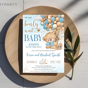 Top-down view of the printed teddy bear card placed on a rustic wooden plate with green leaves.
