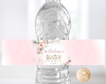 Könnte beinhalten: Rosa-weißes Blumen-Wasserflaschenetikett mit goldener Aufschrift "Melissa's Baby Shower 01.01.20XX". Das Etikett hat einen rosa Hintergrund mit weißem Rand und einem goldenen Herzen.