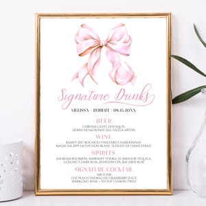 May include: A printable wedding sign with a pink bow at the top. The sign lists signature drinks for the wedding reception, including beer, wine, spirits, and a signature cocktail called "Mr. Funk".