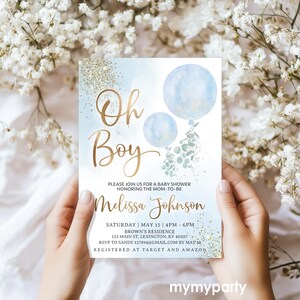 Hands holding the printed watercolor and gold glitter Oh Boy baby shower invite card.