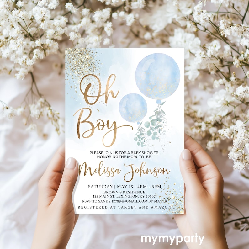 Hands holding the printed watercolor and gold glitter Oh Boy baby shower invite card.