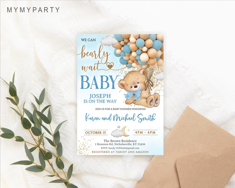 The announcement invitation standing next to a blank brown kraft envelope and green eucalyptus branches.