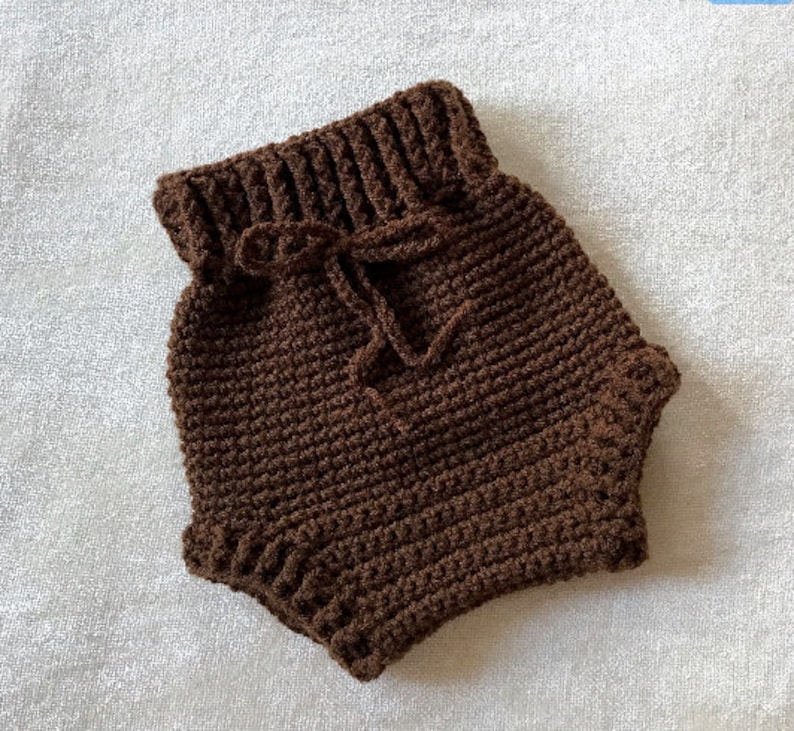 Puede incluir: Bombachos de beb&eacute; de crochet marr&oacute;n con cintura de cord&oacute;n.
