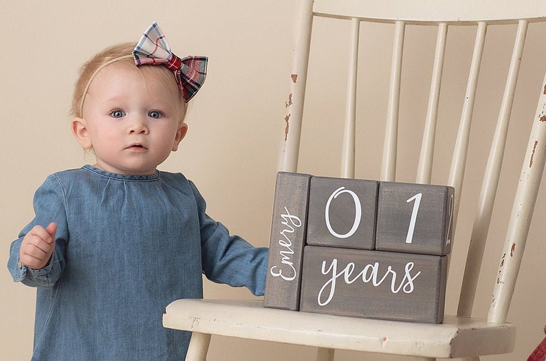 Milestone blocks personalized by Birchmark Designs in Willow script font with a one year old baby
